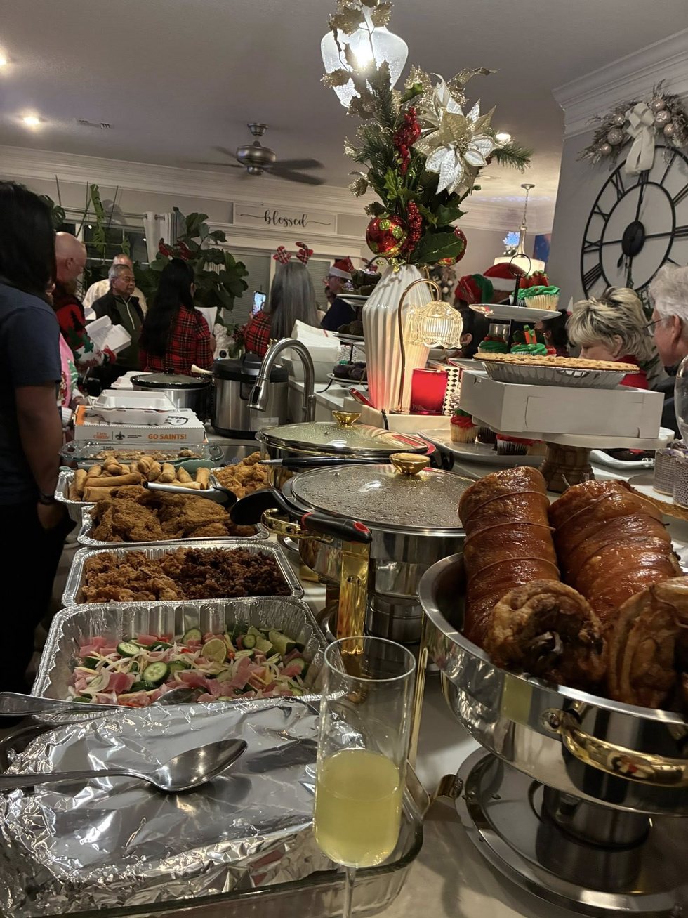 A celebration food table with lechon and other dishes prepared for a community gathering.