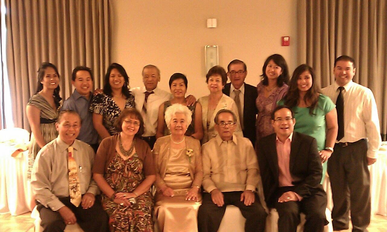A formal group portrait of Filipino-American community members at an event.
