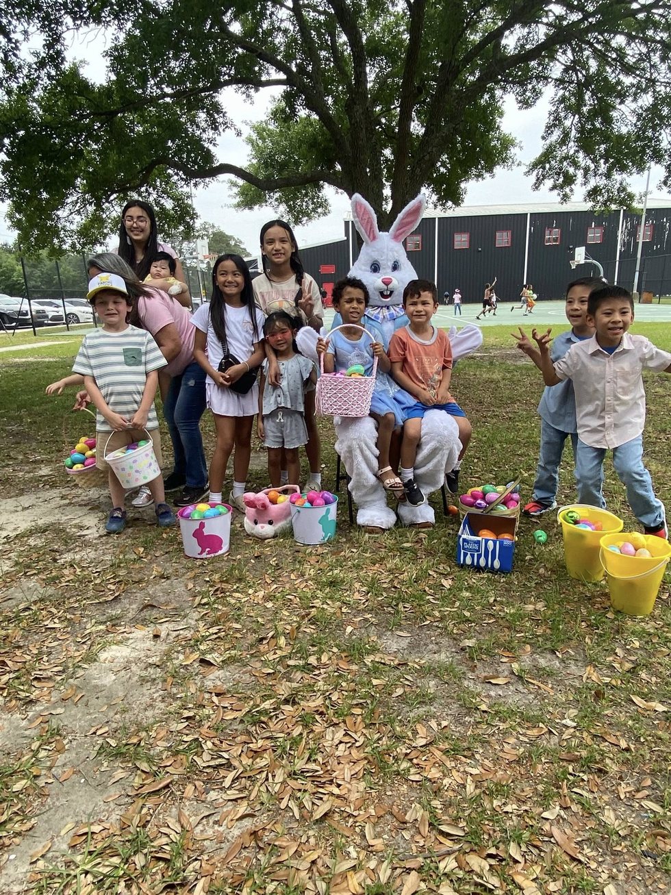 Families and children gathered outdoors after a community activity.